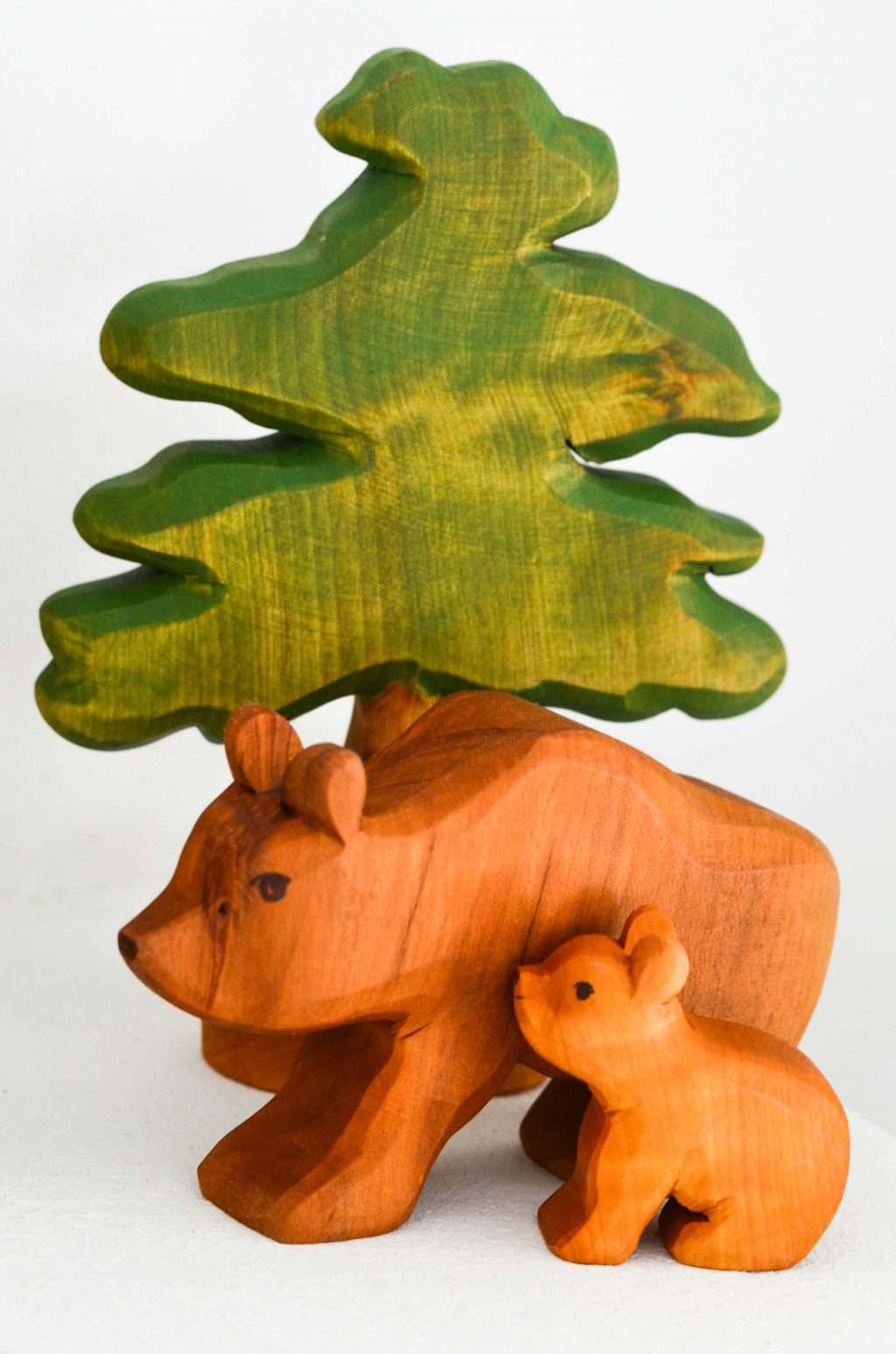 Predan wooden bears and leafy tree